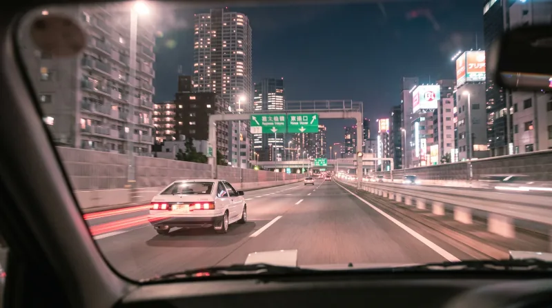 White Japanese sports coupe on an elevated Tokyo expressway at night. — Nano Banana 2.1